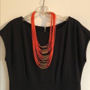 Orange leather and gold necklace. Adjustable.